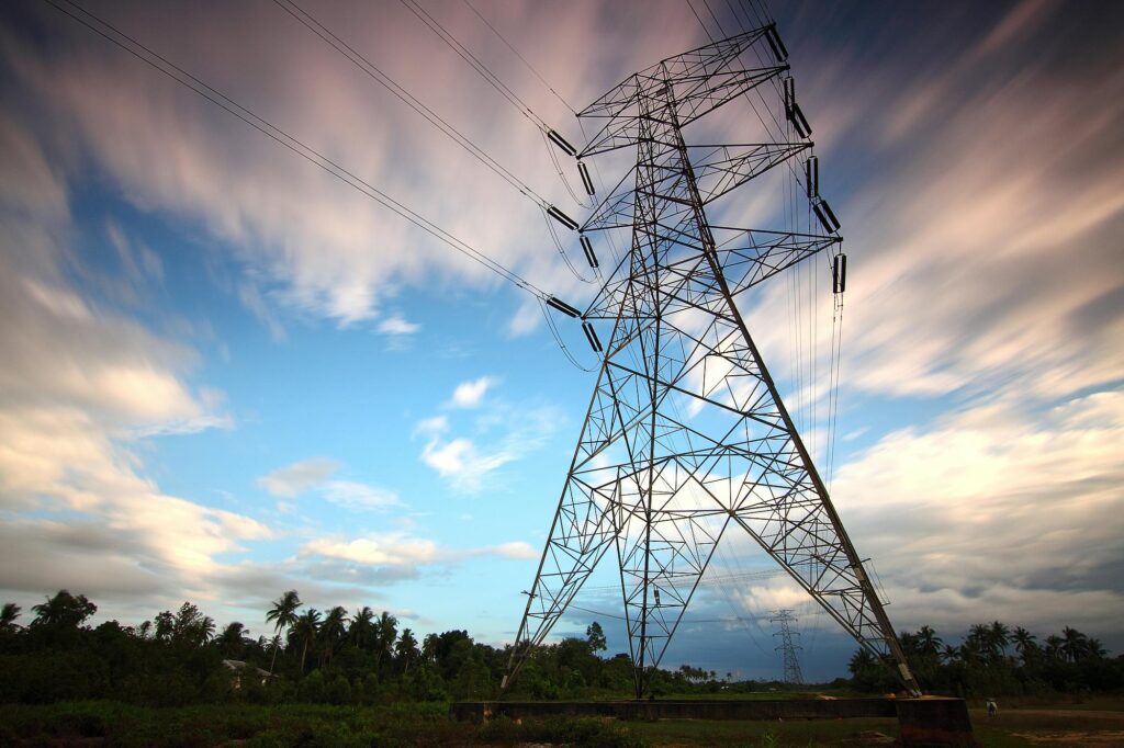 Service-2-min Stunning view of a towering power line against a vibrant sky, showcasing energy infrastructure in nature.